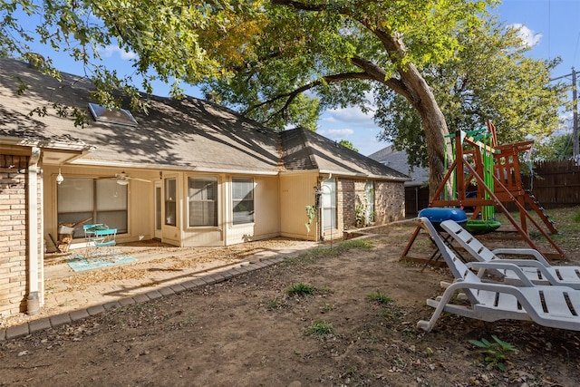 rear view of house with a patio and a playground