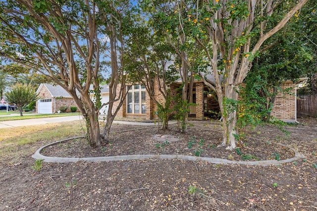 obstructed view of property with a garage