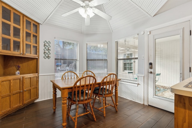 dining room with lofted ceiling, dark wood-type flooring, and plenty of natural light