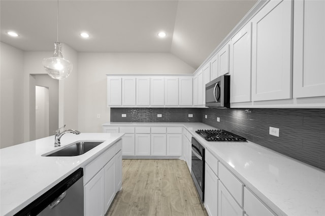 kitchen featuring pendant lighting, sink, white cabinets, and appliances with stainless steel finishes