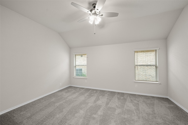 carpeted empty room featuring ceiling fan and lofted ceiling