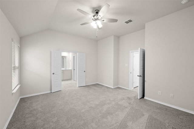 unfurnished bedroom with light carpet, vaulted ceiling, and ceiling fan