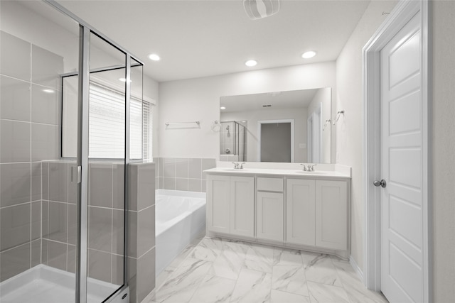 bathroom with shower with separate bathtub and vanity