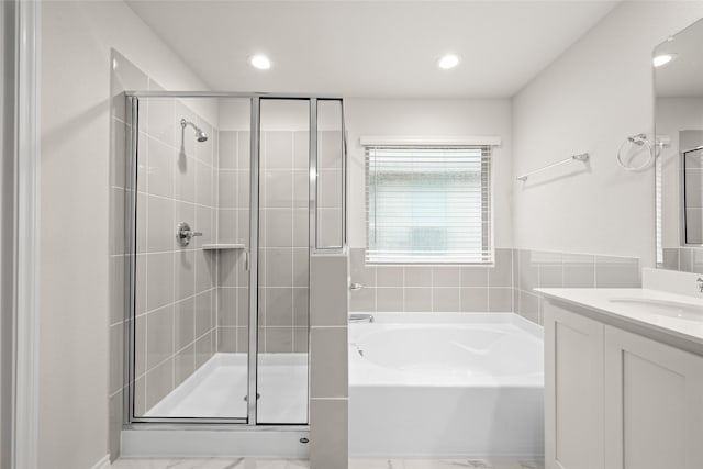 bathroom featuring vanity and separate shower and tub