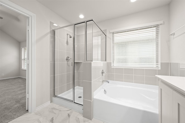 bathroom featuring independent shower and bath, vanity, and plenty of natural light