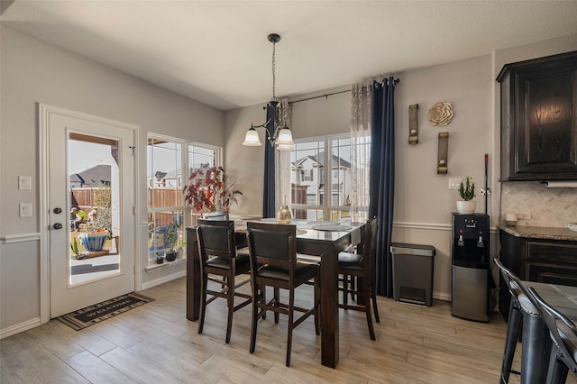 dining space featuring a chandelier and light hardwood / wood-style flooring