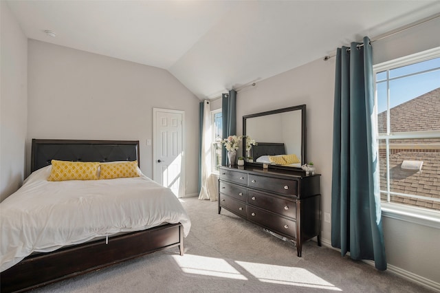 carpeted bedroom featuring lofted ceiling