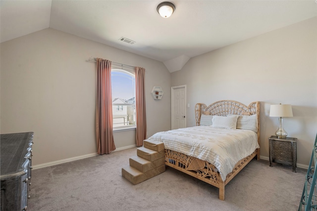 bedroom with lofted ceiling and carpet