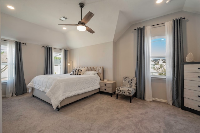 carpeted bedroom featuring ceiling fan, lofted ceiling, and multiple windows