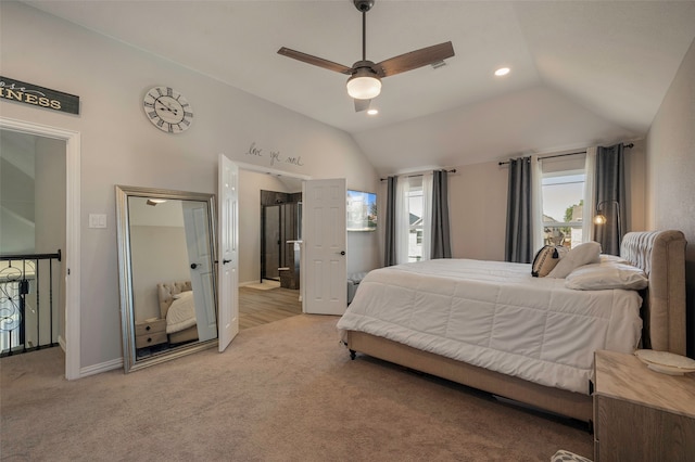 bedroom featuring vaulted ceiling, light colored carpet, and ceiling fan