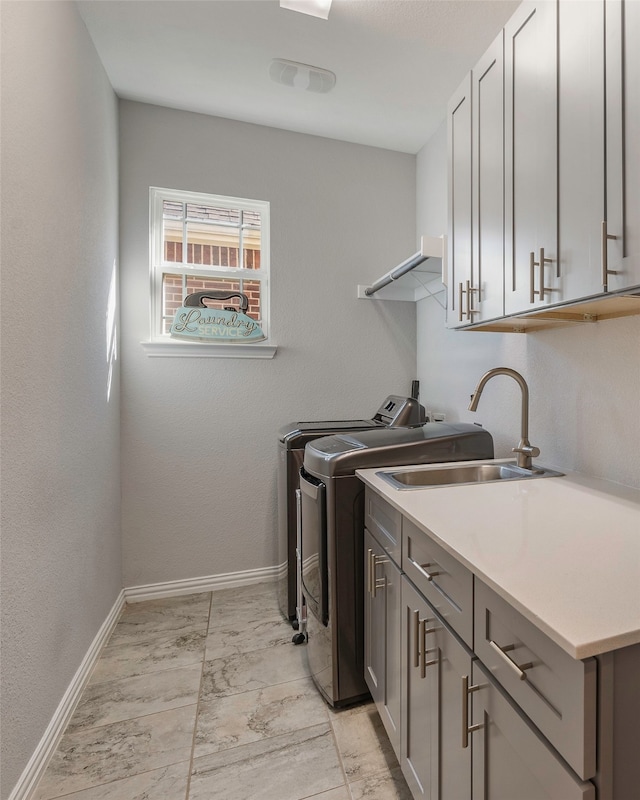 laundry room featuring sink, cabinets, and washing machine and clothes dryer