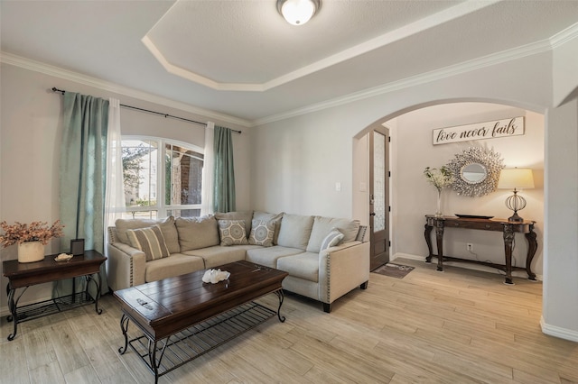 living room featuring crown molding and light hardwood / wood-style floors