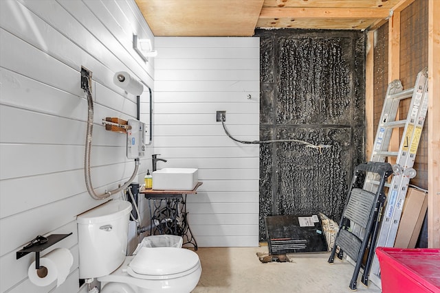 bathroom with sink, wood ceiling, concrete flooring, toilet, and wooden walls