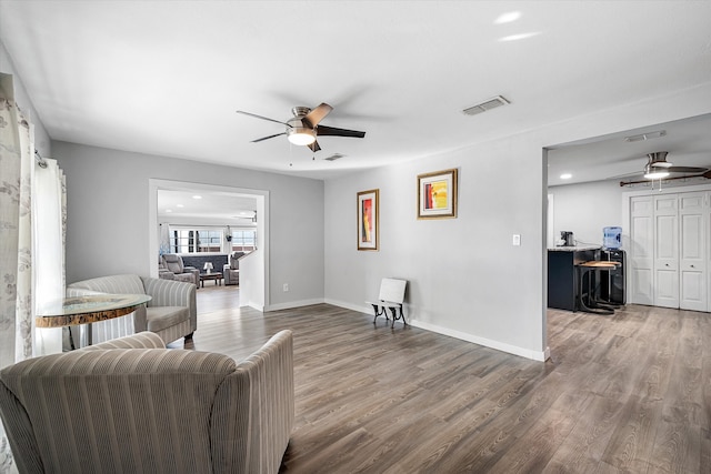 living room with ceiling fan and dark hardwood / wood-style floors