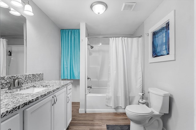 full bathroom with vanity, shower / tub combo with curtain, wood-type flooring, and toilet