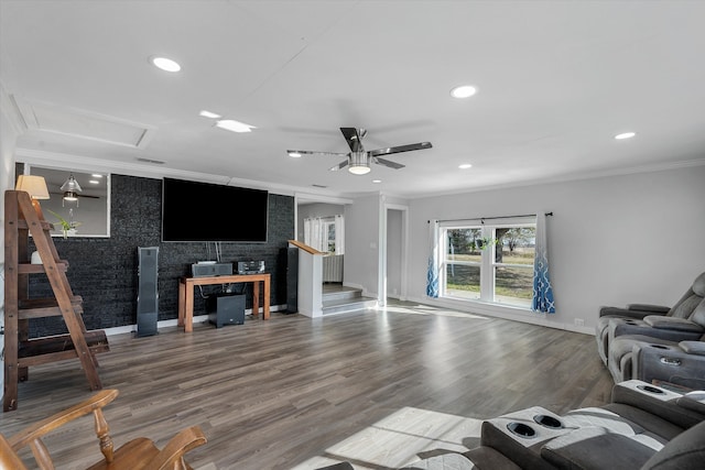 living room with ornamental molding, hardwood / wood-style floors, tile walls, and ceiling fan