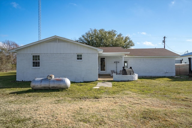 rear view of property featuring a lawn