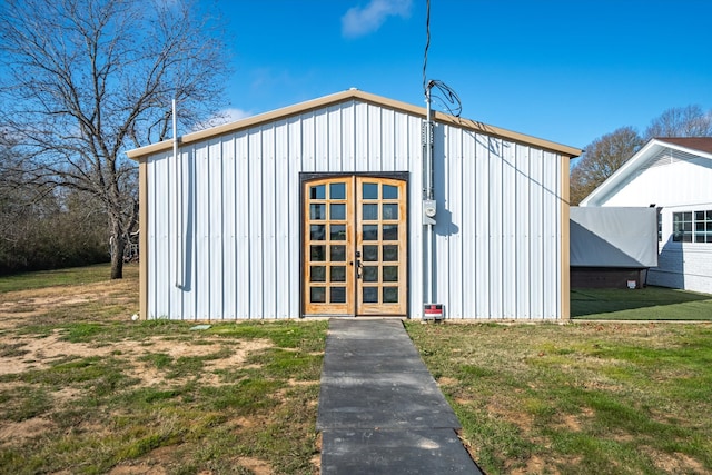 view of outbuilding featuring a lawn