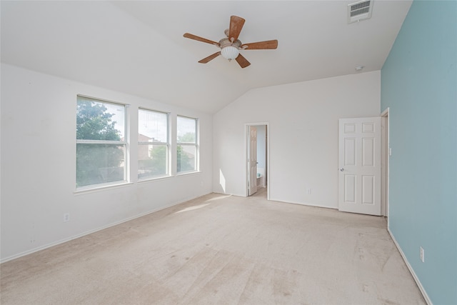 carpeted empty room featuring ceiling fan and lofted ceiling