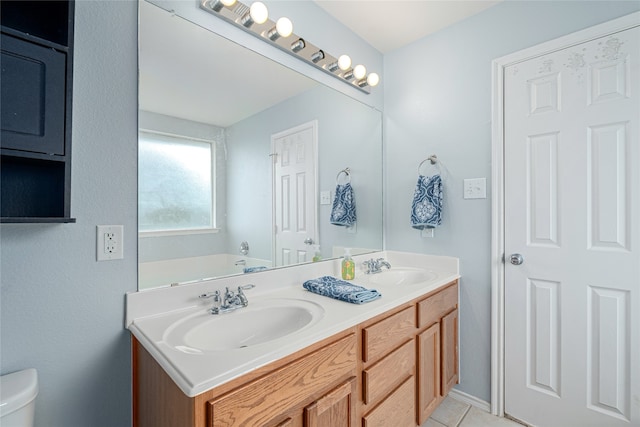 bathroom featuring tile patterned flooring, vanity, and toilet