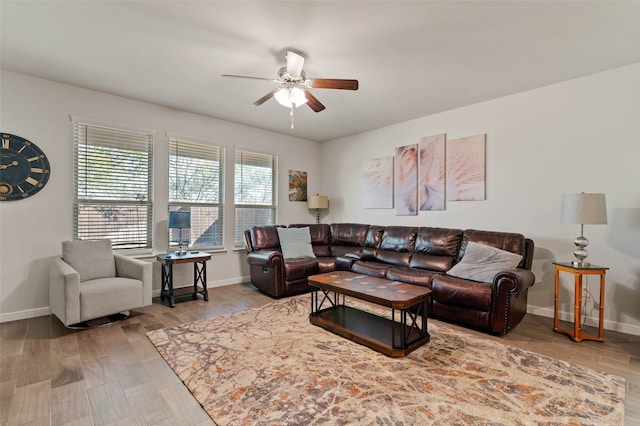 living room featuring ceiling fan and wood-type flooring