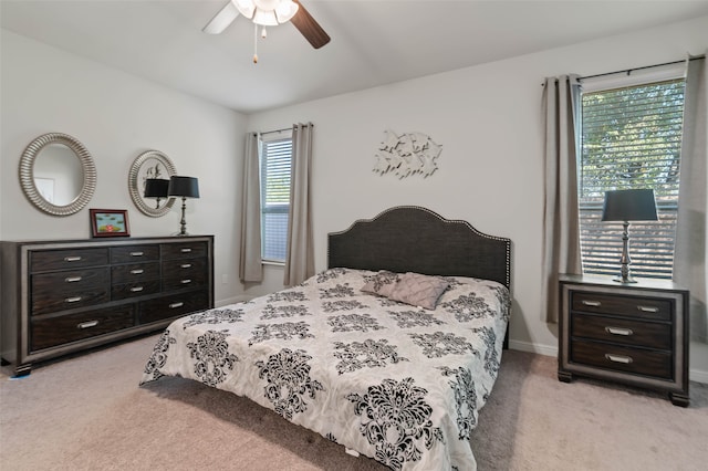 bedroom featuring light colored carpet and ceiling fan