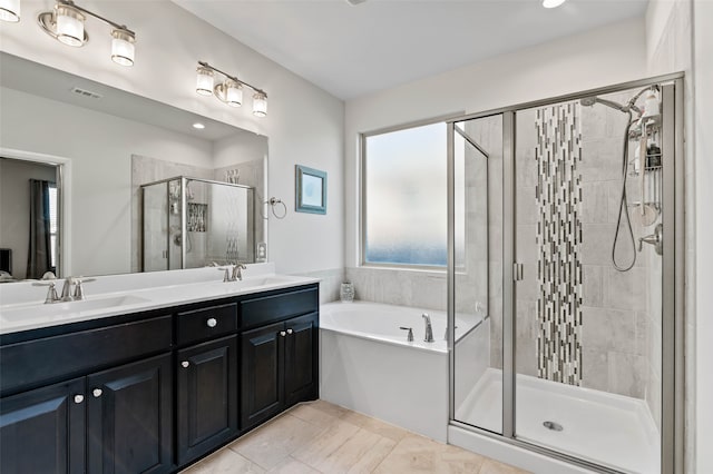 bathroom featuring tile patterned flooring, shower with separate bathtub, and vanity