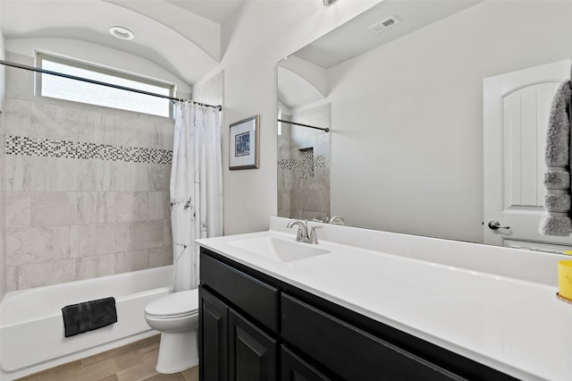 full bathroom with shower / bath combo, vanity, hardwood / wood-style flooring, and toilet