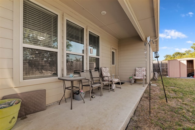 view of patio featuring a storage shed