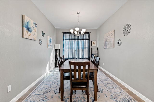 dining space featuring a notable chandelier and wood-type flooring