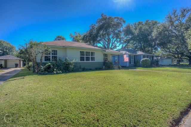 single story home with a front yard and a garage