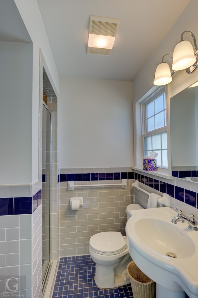 bathroom with walk in shower, tile walls, toilet, and tile patterned flooring