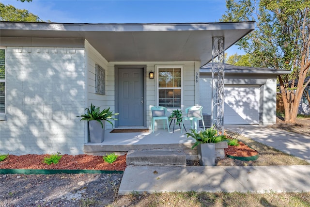 property entrance featuring covered porch and a garage