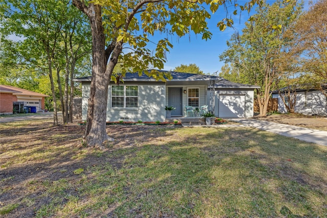 single story home featuring a porch, a front yard, and a garage