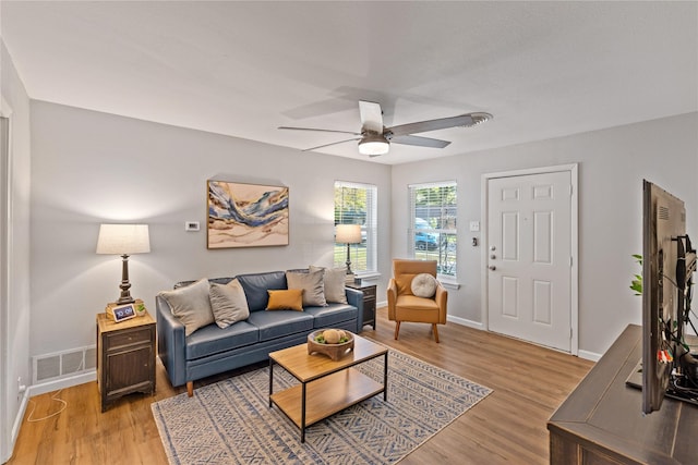 living room featuring light hardwood / wood-style floors and ceiling fan