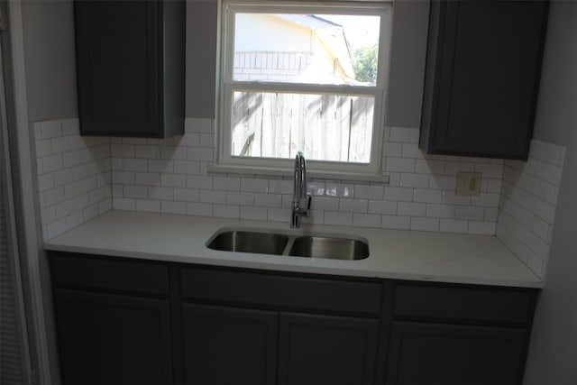 kitchen featuring tasteful backsplash and sink