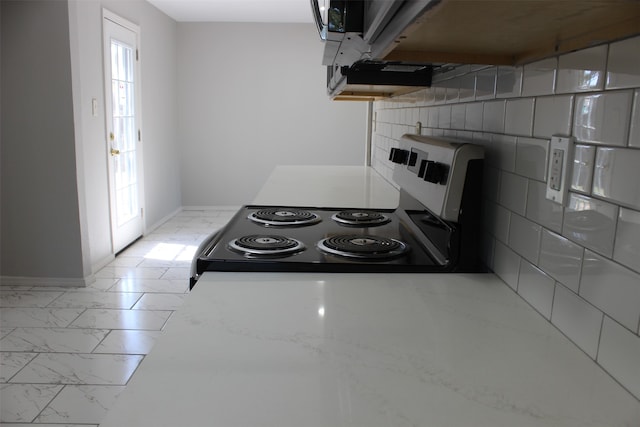 kitchen with tile walls and electric stove