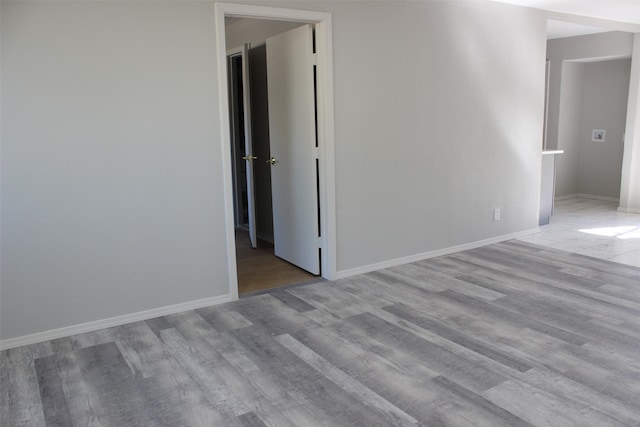 unfurnished room with light wood-type flooring