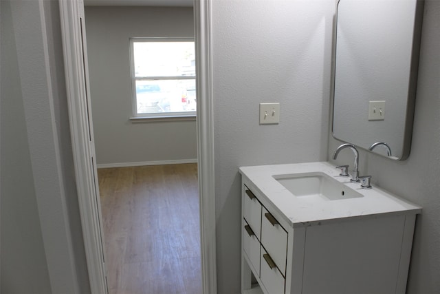 bathroom with vanity and hardwood / wood-style floors