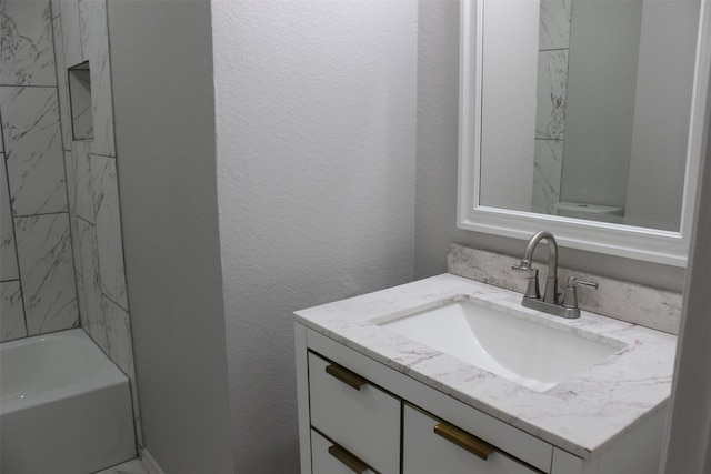 bathroom featuring vanity and tiled shower / bath combo