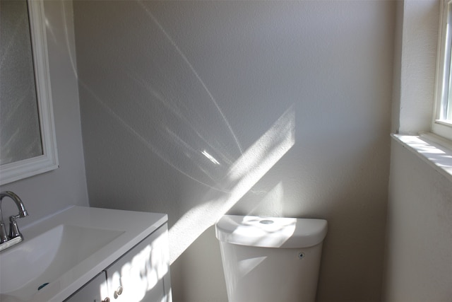 bathroom featuring toilet and vanity