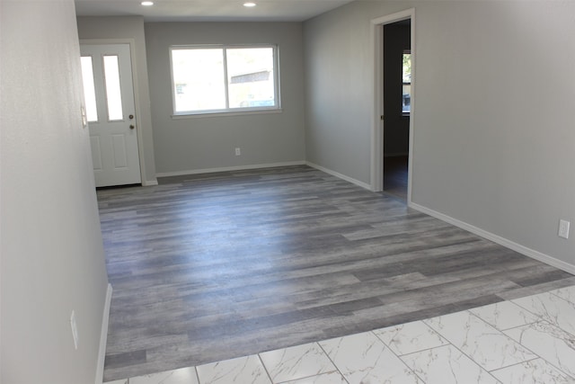 empty room with light hardwood / wood-style flooring