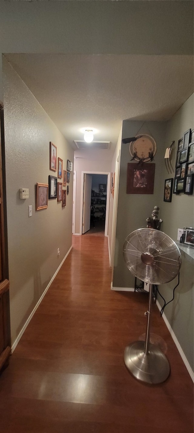 hallway with hardwood / wood-style flooring