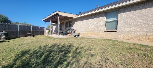 exterior space with a patio area and a lawn