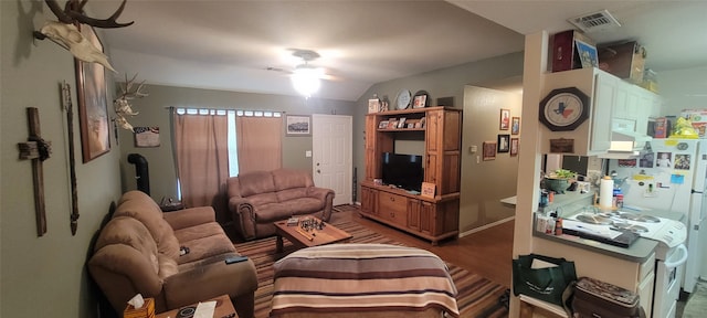 living room with lofted ceiling, ceiling fan, and dark hardwood / wood-style flooring