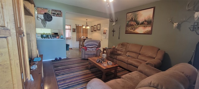 living room with a notable chandelier and hardwood / wood-style floors