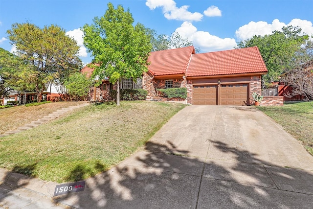 view of front of home featuring a front yard and a garage