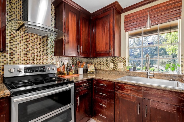 kitchen featuring backsplash, light stone counters, sink, wall chimney range hood, and stainless steel range with electric cooktop