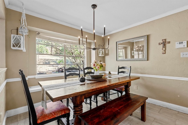 dining area featuring a notable chandelier, light hardwood / wood-style floors, and crown molding