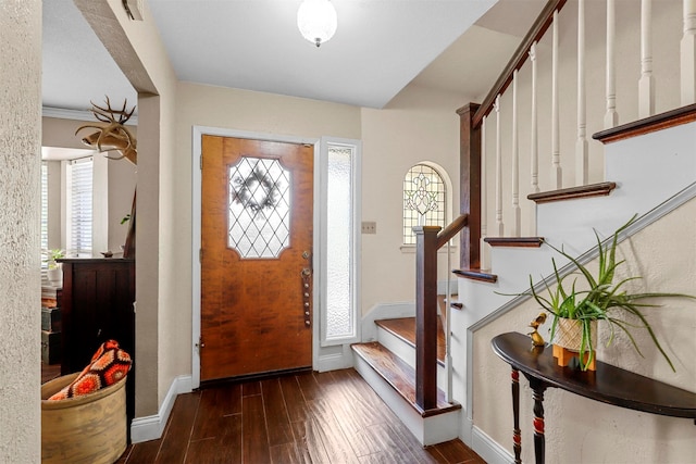 foyer with dark hardwood / wood-style flooring and crown molding